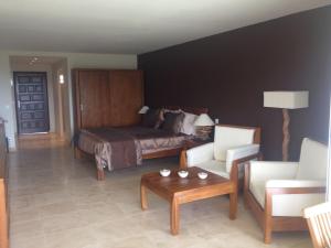 a bedroom with a bed and a couch and a table at European Luxur Tortola 5318 in Cul de Sac