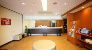 a waiting room with a table and a counter at Hotel Naito Kofu Showa in Showa +141 photos