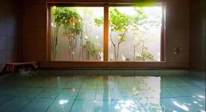 an empty room with a window and a pool at Super Hotel Arai-Niigata in Arai