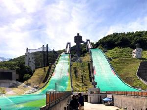 aavyavy slide on top of a hill with people at HAKUBA Moegi HOTEL in Hakuba
