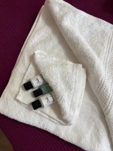 a white towel with three wine bottles on it at Modern & Spacious 3BR House Bracknell - Berkshire in Easthampstead