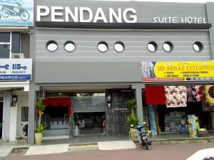 a store with a motorcycle parked in front of it at Pendang Suite Hotel PLT in Pendang