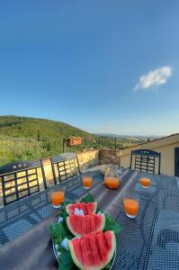 a table with a plate of watermelons on it at La Vecchia Sassa in Montaione
