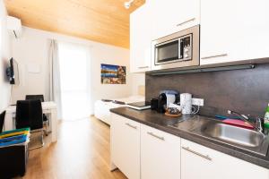a kitchen with a sink and a microwave at 213 Prag, Studio Apartment, 27m2, 1-2 Personen in Klagenfurt
