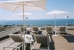 a group of chairs and umbrellas on a balcony at Villa Oriana Relais in Sorrento