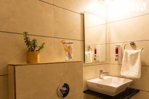 a bathroom with a sink and a mirror at StayVista Residences at Baner - Balewadi with Purifier in Pune