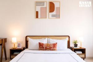 a bedroom with a large bed with two night stands at StayVista Residences at Baner - Balewadi with Purifier in Pune