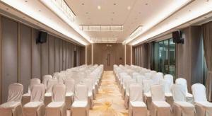 a room with rows of white chairs in a hall at Zhongshan Da Dong Yu Hotel in Zhongshan