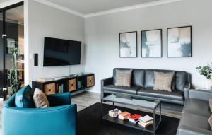 a living room with a couch and a tv at SchönHier in Westerburg