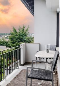 a table and chairs on a balcony with a view at SchönHier in Westerburg