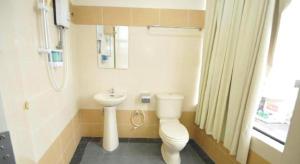 a small bathroom with a toilet and a sink at I-Winton Hotel in Mentekab