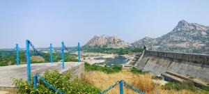 a dam with a river and mountains in the background at Jawai Dam Stay and Leopard Safari 