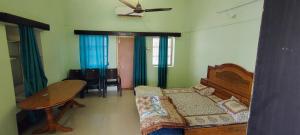 a bedroom with a bed and a table and a table at Jawai Dam Stay and Leopard Safari 