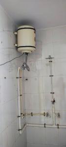 a dirty bathroom with pipes on the wall at Jawai Dam Stay and Leopard Safari 