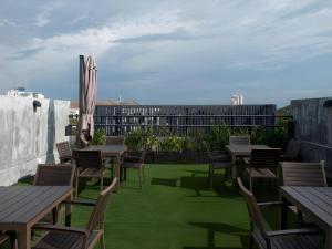 a group of tables and chairs on a patio with grass at Nginap Hotel in Subang Jaya