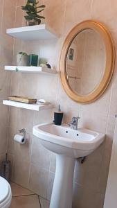 a bathroom with a sink and a mirror at Creative 2 Level Townhouse Near City and Wine Route in Brackenfell