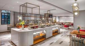 a kitchen with a table with dishes on it at Magnotel Hotel Dongxing Guomen Port in Tung-hsing-shih