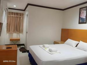 a bedroom with a large white bed in a room at Jeamco Royal Hotel - Pasig in Manila