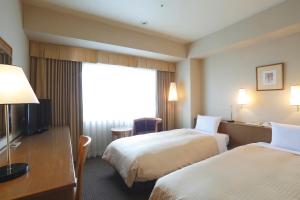 Postel nebo postele na pokoji v ubytování Dai-ichi Hotel Ryogoku