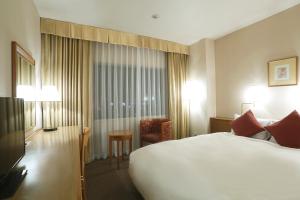 Postel nebo postele na pokoji v ubytování Dai-ichi Hotel Ryogoku