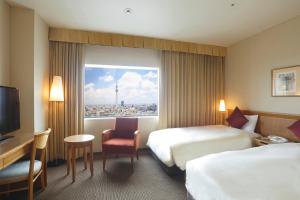 Postel nebo postele na pokoji v ubytování Dai-ichi Hotel Ryogoku