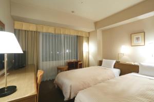 Postel nebo postele na pokoji v ubytování Dai-ichi Hotel Ryogoku