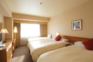 Postel nebo postele na pokoji v ubytování Dai-ichi Hotel Ryogoku