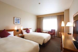 Postel nebo postele na pokoji v ubytování Dai-ichi Hotel Ryogoku