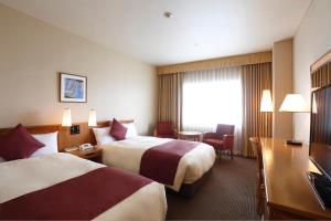 Postel nebo postele na pokoji v ubytování Dai-ichi Hotel Ryogoku