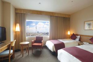 Postel nebo postele na pokoji v ubytování Dai-ichi Hotel Ryogoku