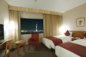 Postel nebo postele na pokoji v ubytování Dai-ichi Hotel Ryogoku