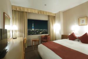 Postel nebo postele na pokoji v ubytování Dai-ichi Hotel Ryogoku