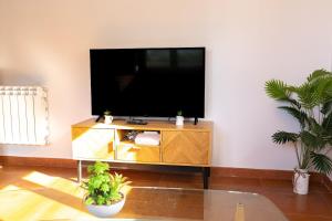 a living room with a flat screen tv on a entertainment center at El Rincon de Onís in Bobia de Abajo