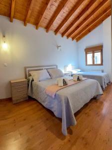 a bedroom with a large bed and a wooden floor at El Rincon de Onís in Bobia de Abajo