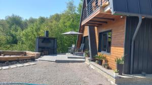 a house with a patio and an outdoor fireplace at Restful Haven  +7 photos