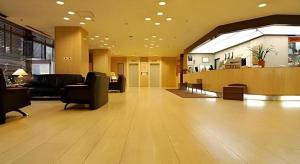 a lobby with couches and chairs in a building at Sunroute Aomori Hotel in Aomori
