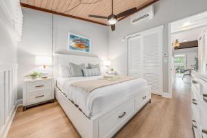 a white bedroom with a large bed and a window at Napili Shores E240 · NS E240 Beautiful Condo w AC Close to Napil in Kahana +41 photos