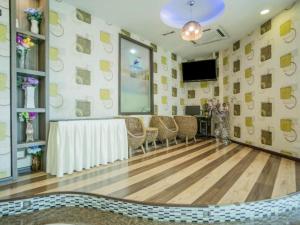 a room with a table and chairs and a flat screen tv at Swing & Pillows - Sky Star, KLIA 1 KLIA 2, Sepang in Sepang