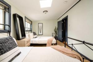 a bedroom with two beds and a balcony at Stay Portland - Moab Vibes in PDX- Walk to Local Coffee & Food in Portland