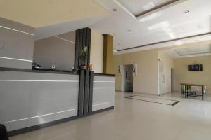an empty room with a counter in a building at MANDARI HOTEL SINGARAJA in Singaraja
