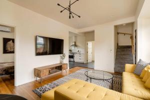 a living room with a couch and a table at Stay Portland - Restored Farmhouse & Backyard Tiny House Village in Portland