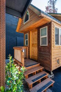a wooden cabin with a deck and stairs at Stay Portland - Tiny Log Cabin - Walk to Local Shops & Eateries in Portland