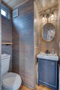 a bathroom with a toilet and a sink and a mirror at Stay Portland - Tiny Aztec - Walk to Local Shops & Restaurants in Portland +11 photos