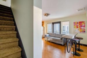 a living room with a couch and a staircase at Stay Portland - Color Splash Apartment in the Heart of Portland in Portland +21 photos