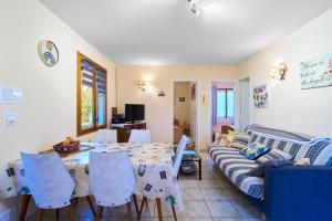 a living room with a table and a couch at La petite maison a la campagne in Nantheuil