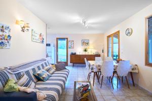 a living room with a couch and a table at La petite maison a la campagne in Nantheuil