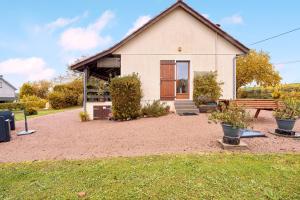 a house with a bench in front of it at La petite maison a la campagne in Nantheuil
