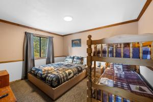 a bedroom with two bunk beds and a window at Bear Canyon: Large Cabin, Beautiful Views & HotTub in Big Bear Lake
