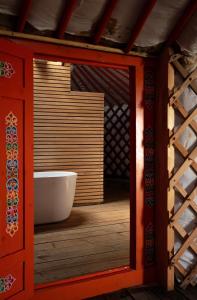 a bathroom with a white tub in a room at Yeruu lodge in Jargalant