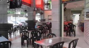 a dining room with tables and chairs in a restaurant at OYO 89717 Budget Star Hotel in Kuala Lumpur